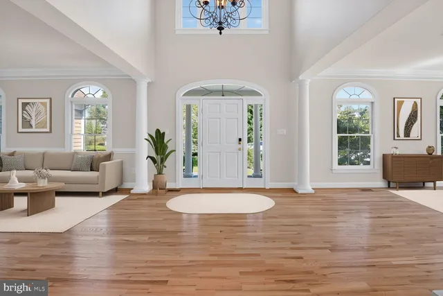 a living room with furniture wooden floor and a large window