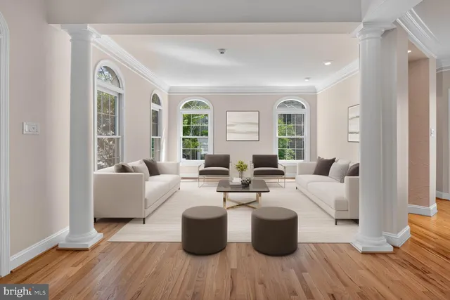 a living room with fireplace furniture and a large window