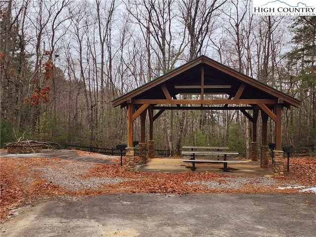 a backyard of a house with barbeque oven table and chairs