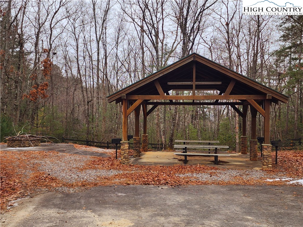 149 Sutter's Ridge Road McGrady, NC 28649 - Photo 6 of 8 a backyard of a house with barbeque oven table and chairs