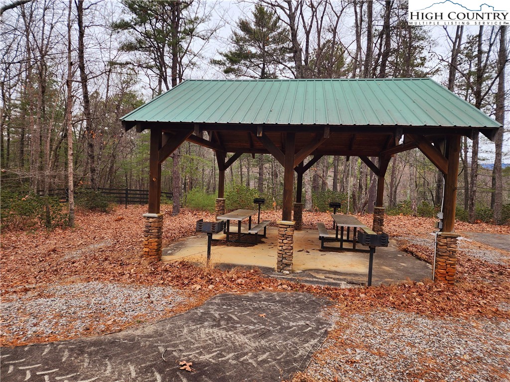 149 Sutter's Ridge Road McGrady, NC 28649 - Photo 7 of 8 a view of house with backyard and outdoor seating
