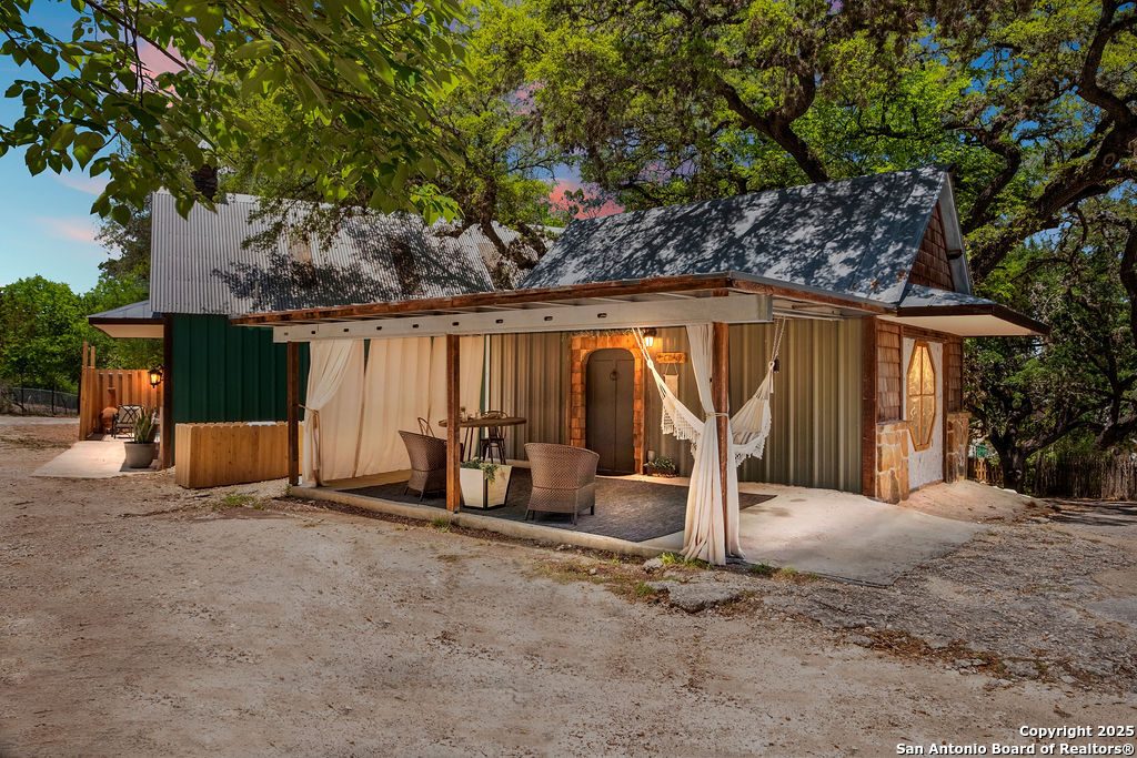 24159 Boerne Stage Road San Antonio, TX 78255 - Photo 3 of 100 a view of a patio with table and chairs and potted plants