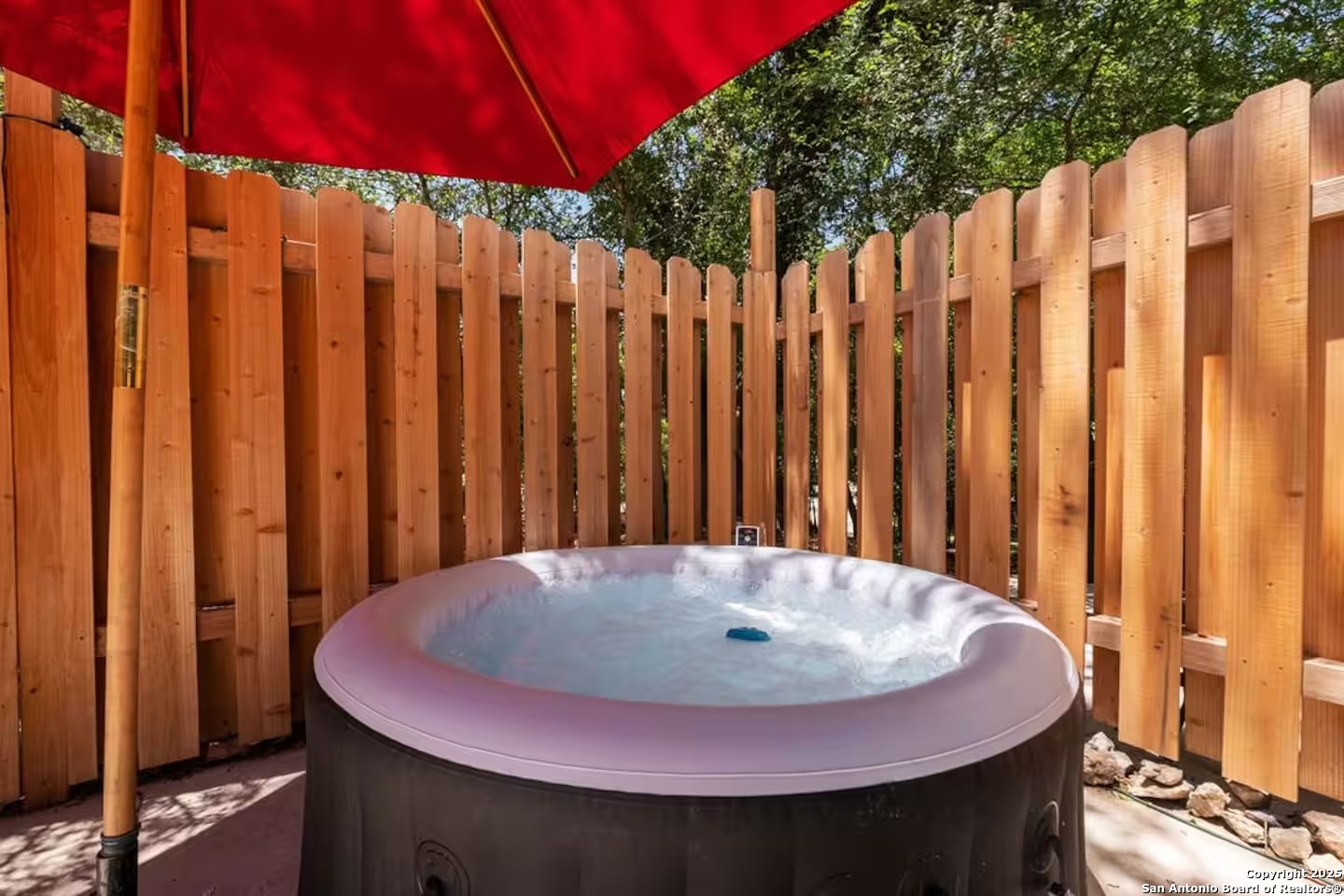 24159 Boerne Stage Road San Antonio, TX 78255 - Photo 33 of 100 a view of a bedroom with a pot and wooden fence