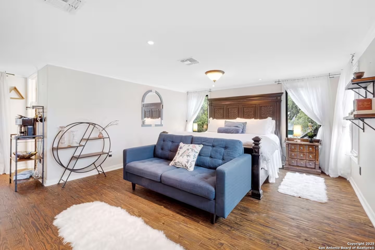 24159 Boerne Stage Road San Antonio, TX 78255 - Photo 41 of 100 a spacious bedroom with a bed a couch and dresser