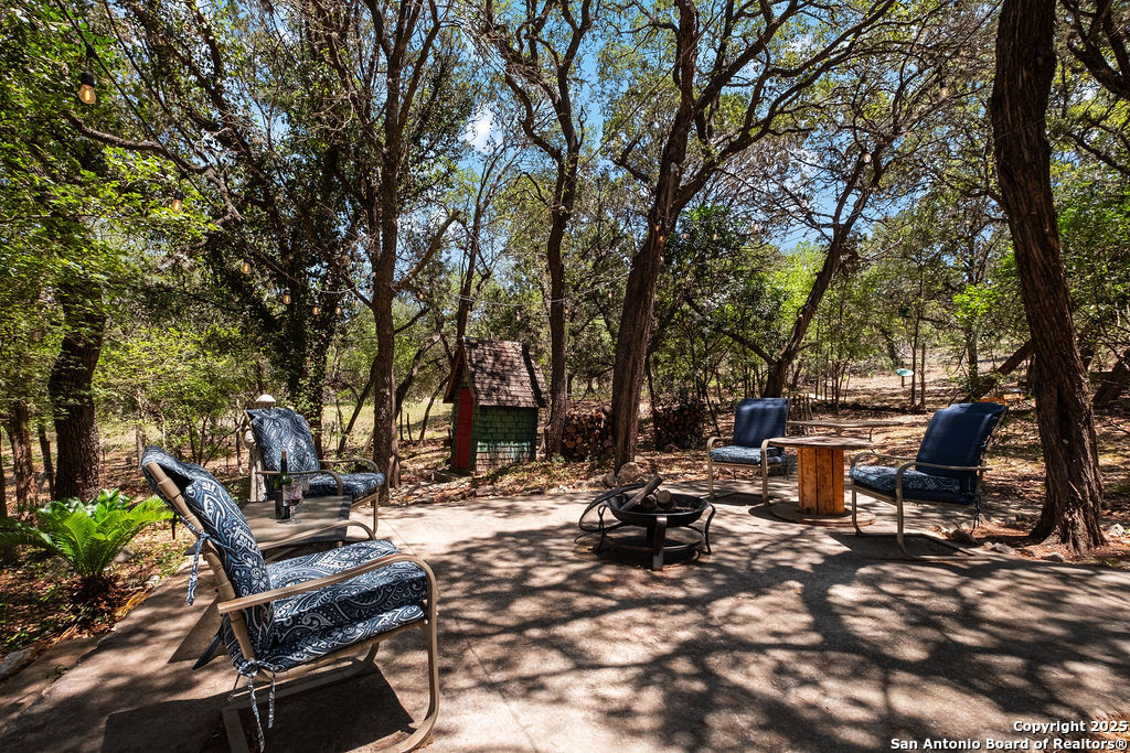 24159 Boerne Stage Road San Antonio, TX 78255 - Photo 47 of 100 a backyard of a house with table and chairs