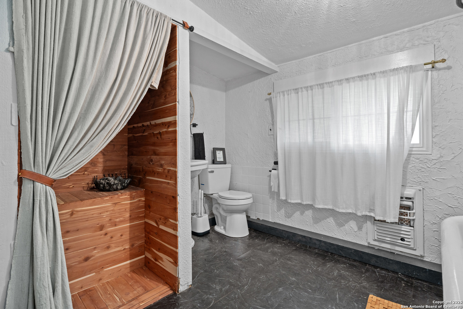 24159 Boerne Stage Road San Antonio, TX 78255 - Photo 72 of 100 a bathroom with a toilet a sink and mirror