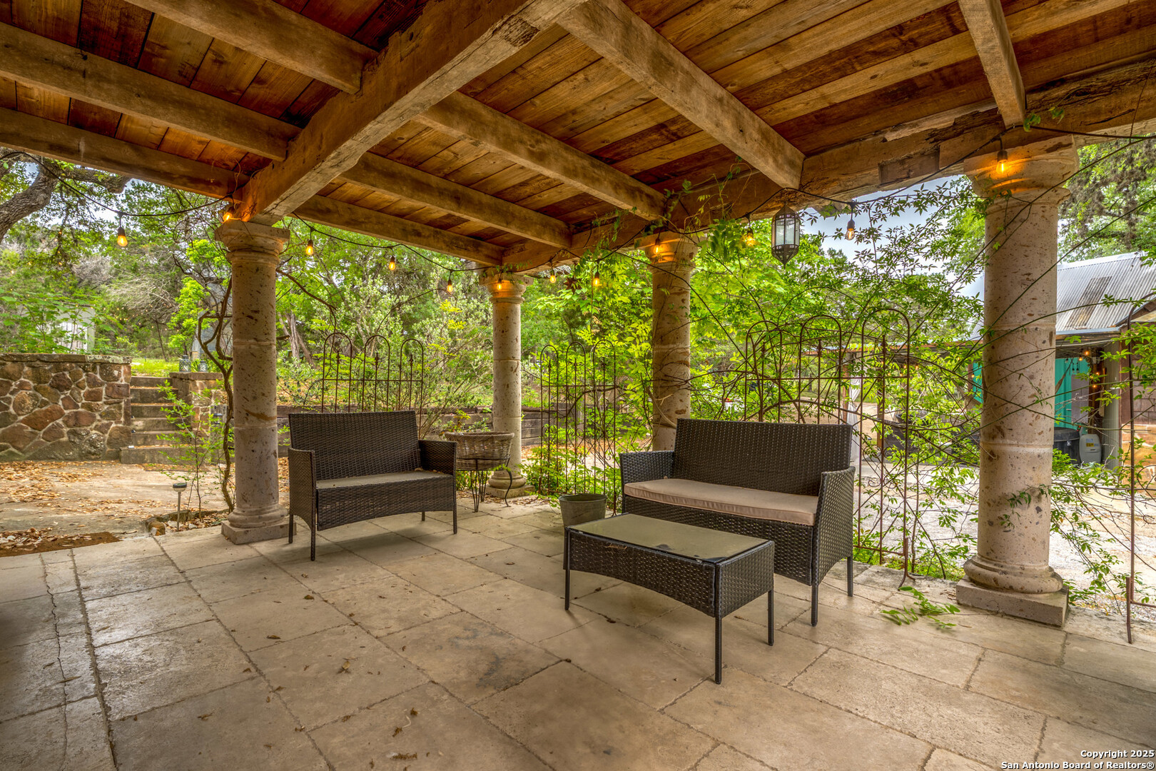 24159 Boerne Stage Road San Antonio, TX 78255 - Photo 90 of 100 a outdoor sitting area with couch and wooden shade