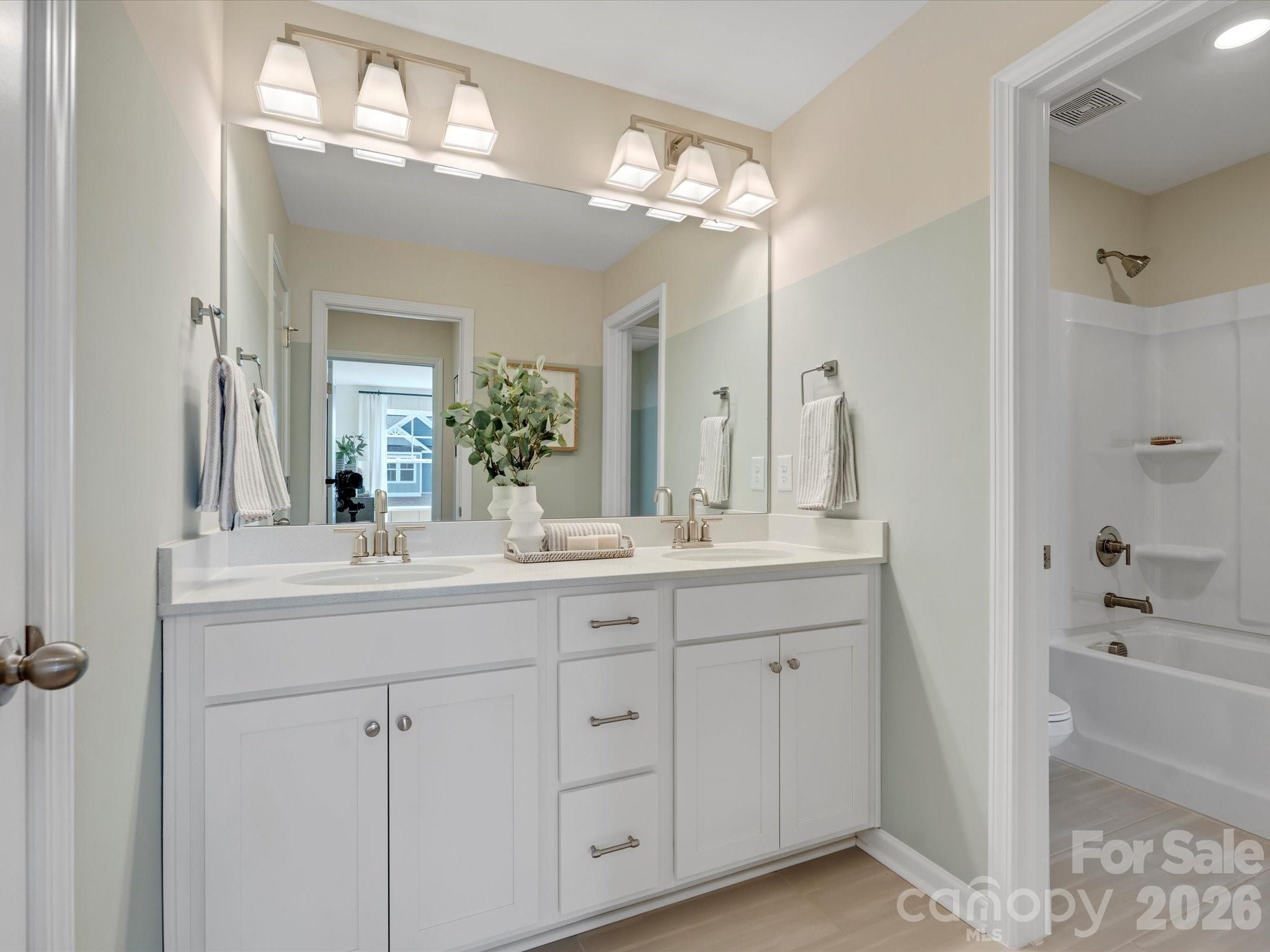4050 Puddle Pond Road Indian Trail, NC 28079 - Photo 15 of 22 a bathroom with a double vanity sink mirror and next to a window