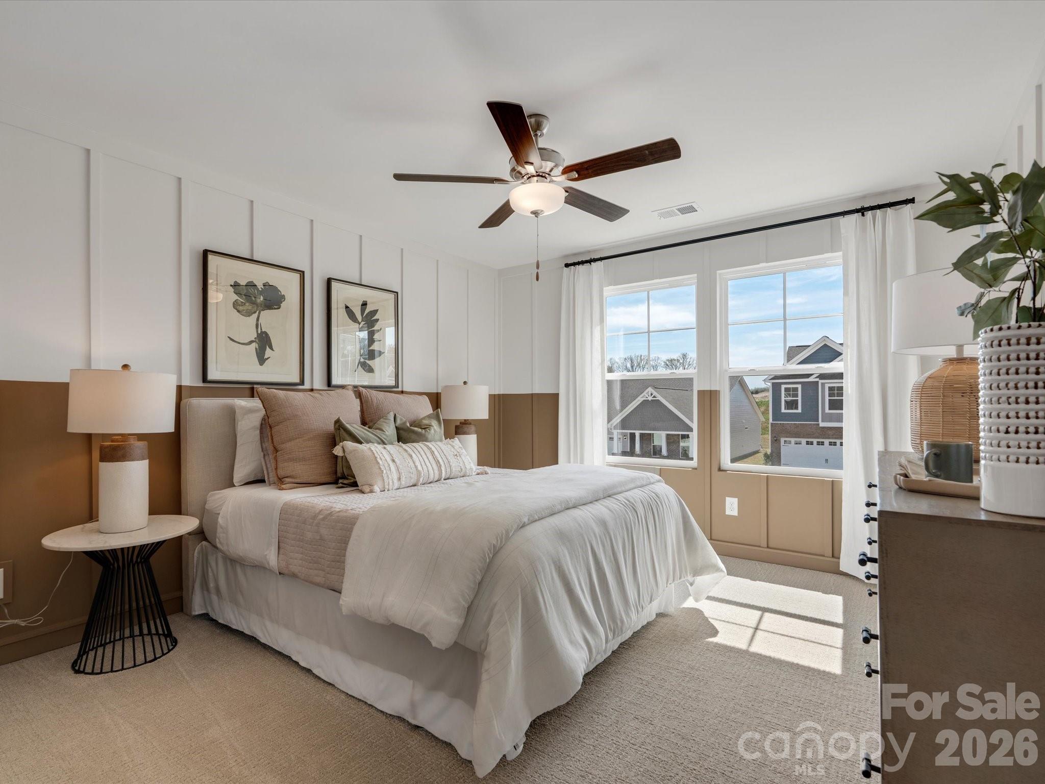4050 Puddle Pond Road Indian Trail, NC 28079 - Photo 16 of 22 a bedroom with a large bed and a chandelier