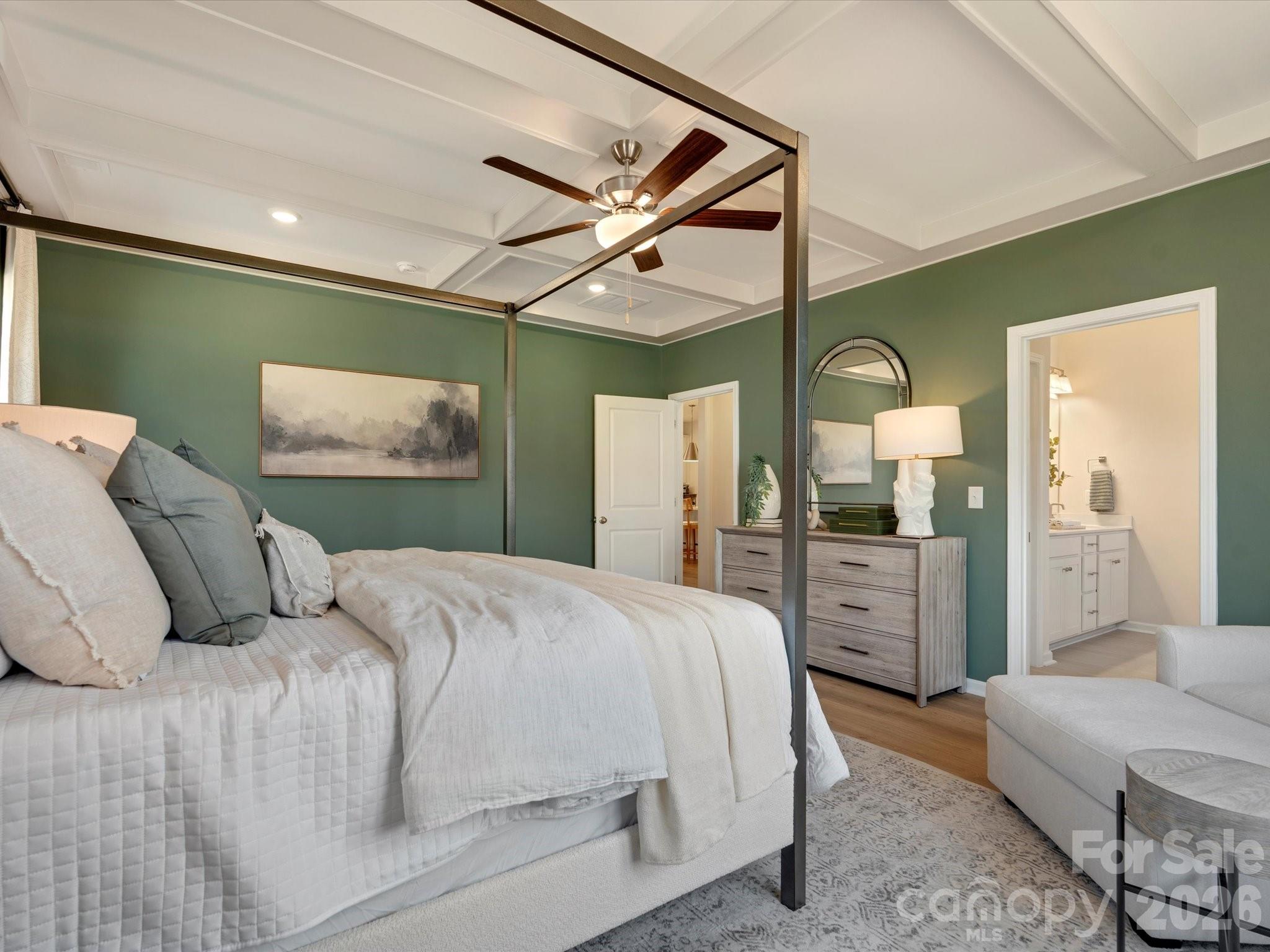 4050 Puddle Pond Road Indian Trail, NC 28079 - Photo 10 of 22 a bedroom with a large bed and a chandelier
