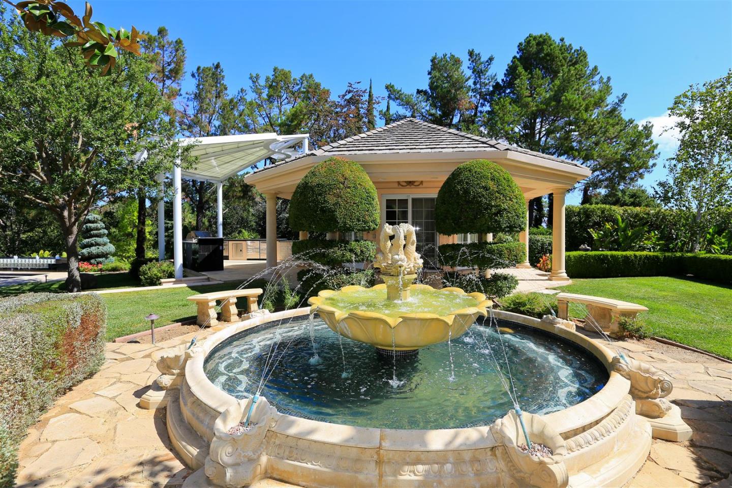 24289 Hillview Road Los Altos Hills, CA 94024 - Photo 20 of 32 a view of a house with backyard fountain and sitting area