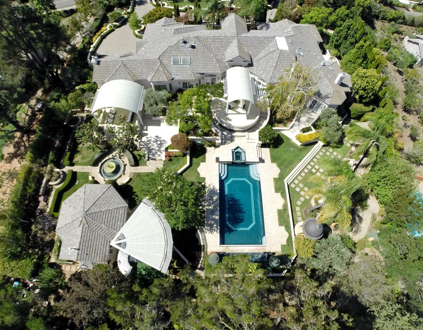 24289 Hillview Road Los Altos Hills, CA 94024 - Photo 2 of 32 an aerial view of a house with a yard and trees