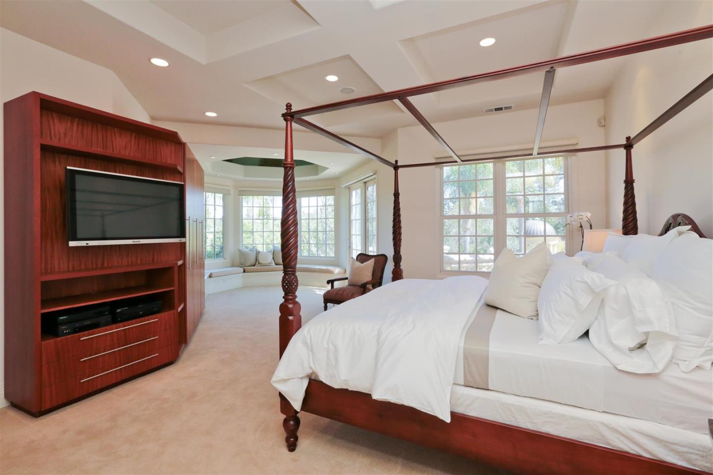 24289 Hillview Road Los Altos Hills, CA 94024 - Photo 21 of 32 a bedroom with a bed and a flat screen tv
