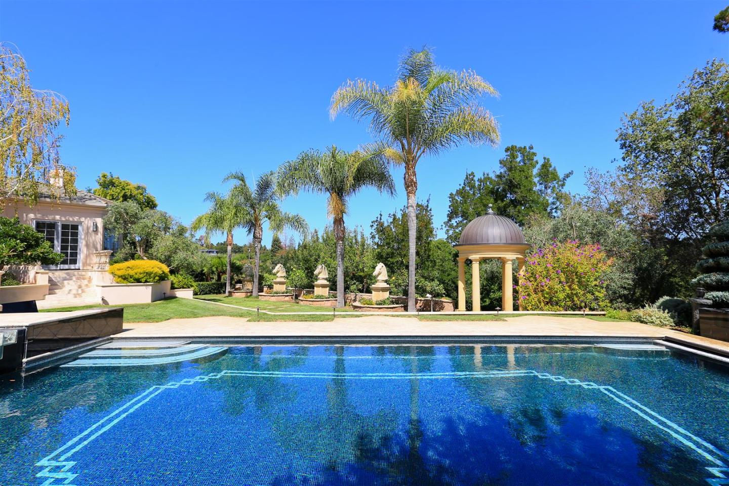 24289 Hillview Road Los Altos Hills, CA 94024 - Photo 25 of 32 a view of a swimming pool with a house in the background