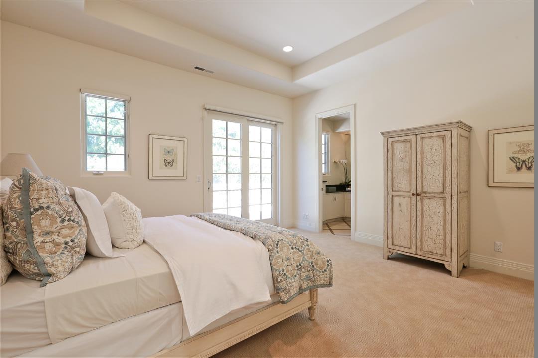 24289 Hillview Road Los Altos Hills, CA 94024 - Photo 27 of 32 a spacious bedroom with a balcony a bed and a window