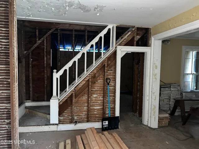 a view of water heater room with stairs