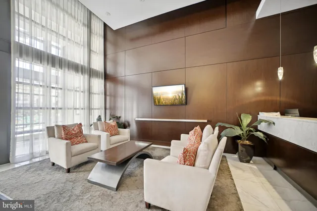a living room with furniture and a floor to ceiling window
