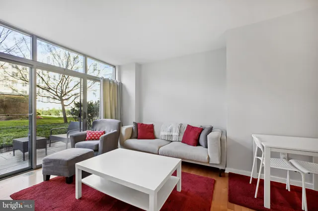 a living room with furniture and a large window