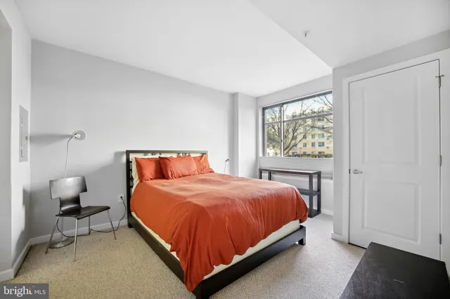 a bed sitting in a bedroom next to a window