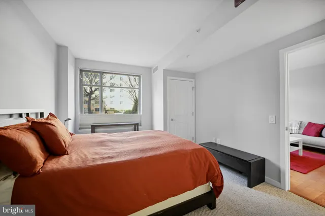 a bed sitting in a bedroom next to a window