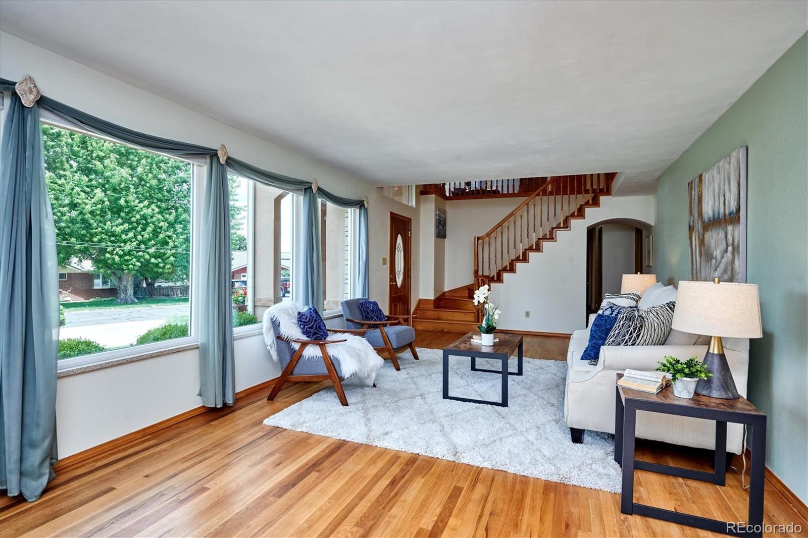 22 Rangeview Drive Wheat Ridge, CO 80215 - Photo 11 of 40 a living room with furniture and a wooden floor