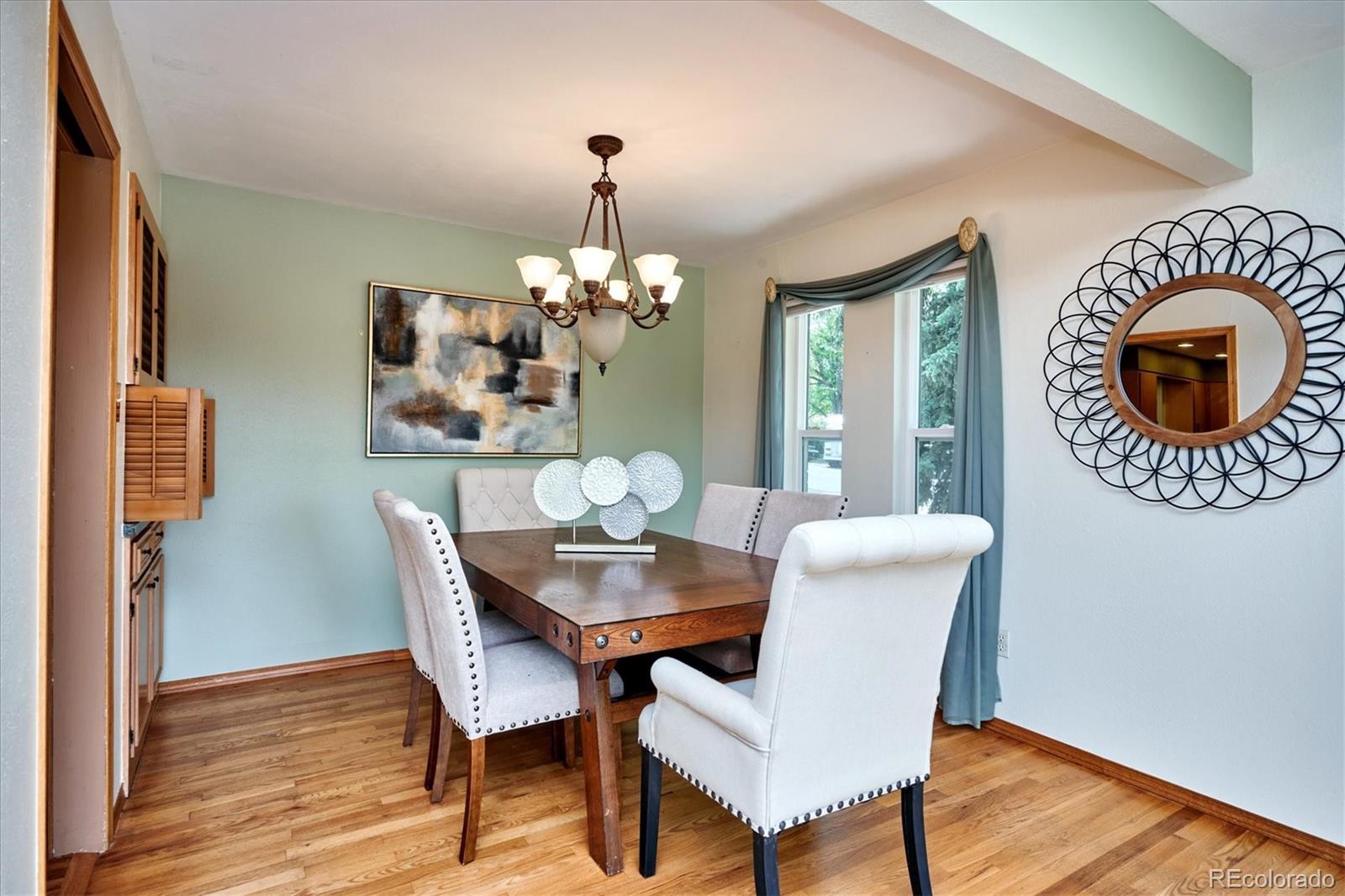 22 Rangeview Drive Wheat Ridge, CO 80215 - Photo 12 of 40 a view of a dining room with furniture and wooden floor