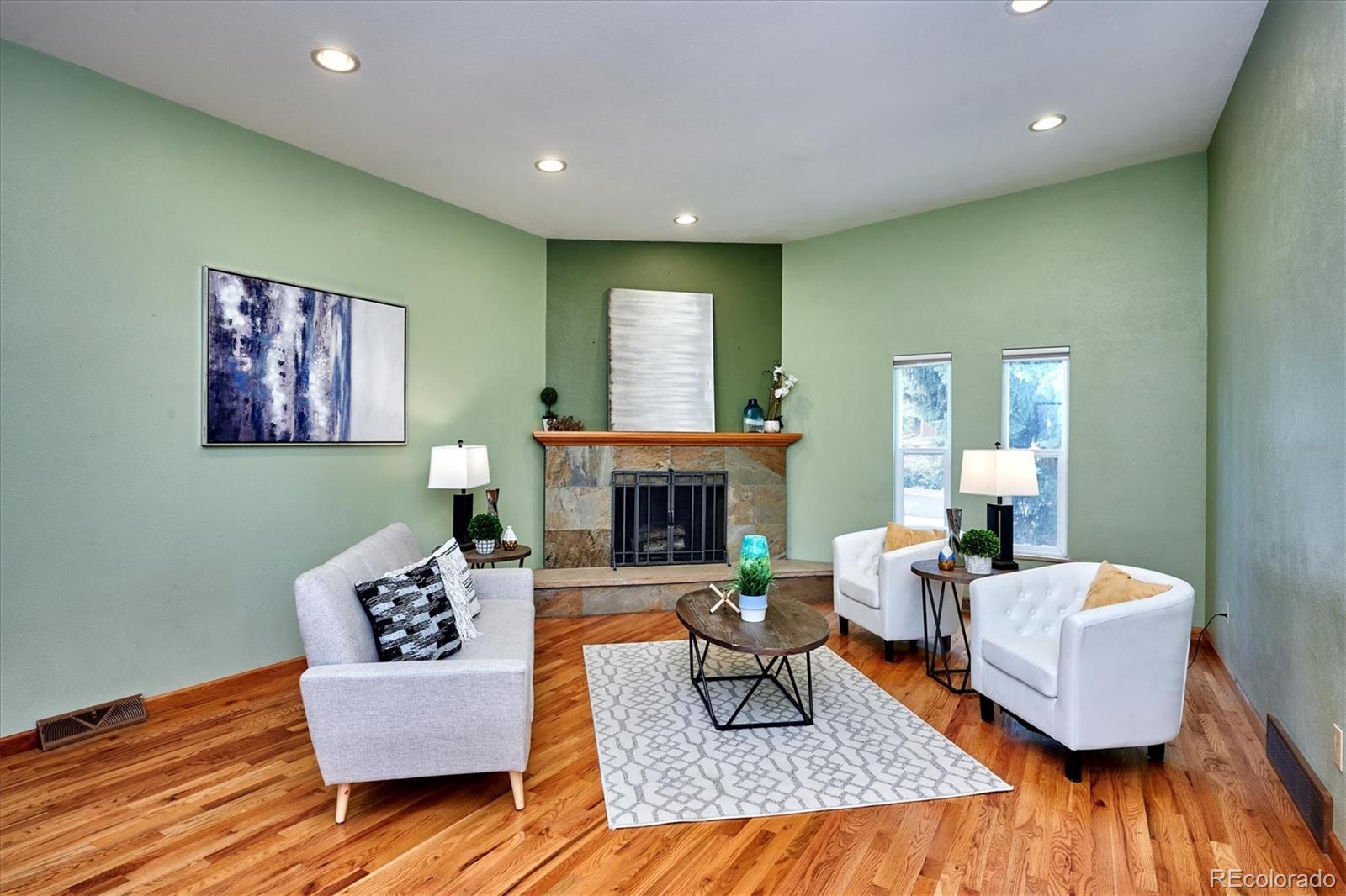 22 Rangeview Drive Wheat Ridge, CO 80215 - Photo 17 of 40 a living room with furniture and a fireplace