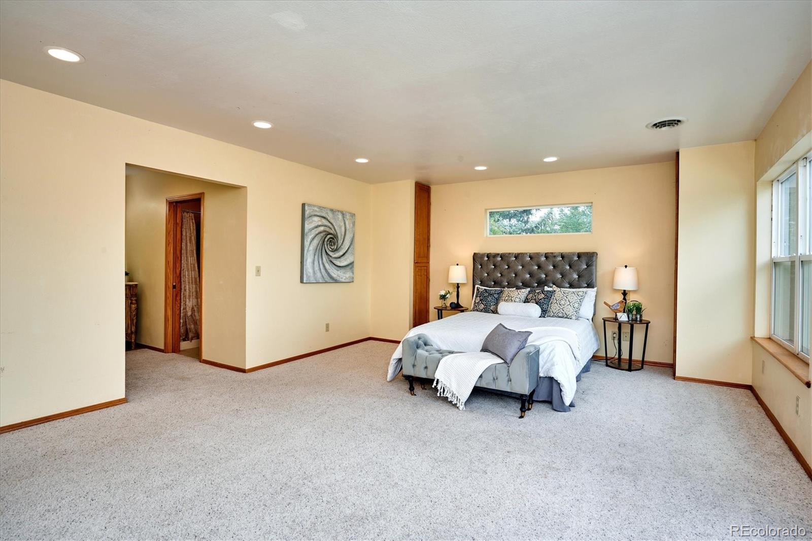 22 Rangeview Drive Wheat Ridge, CO 80215 - Photo 20 of 40 a bed room with a bed and a couch