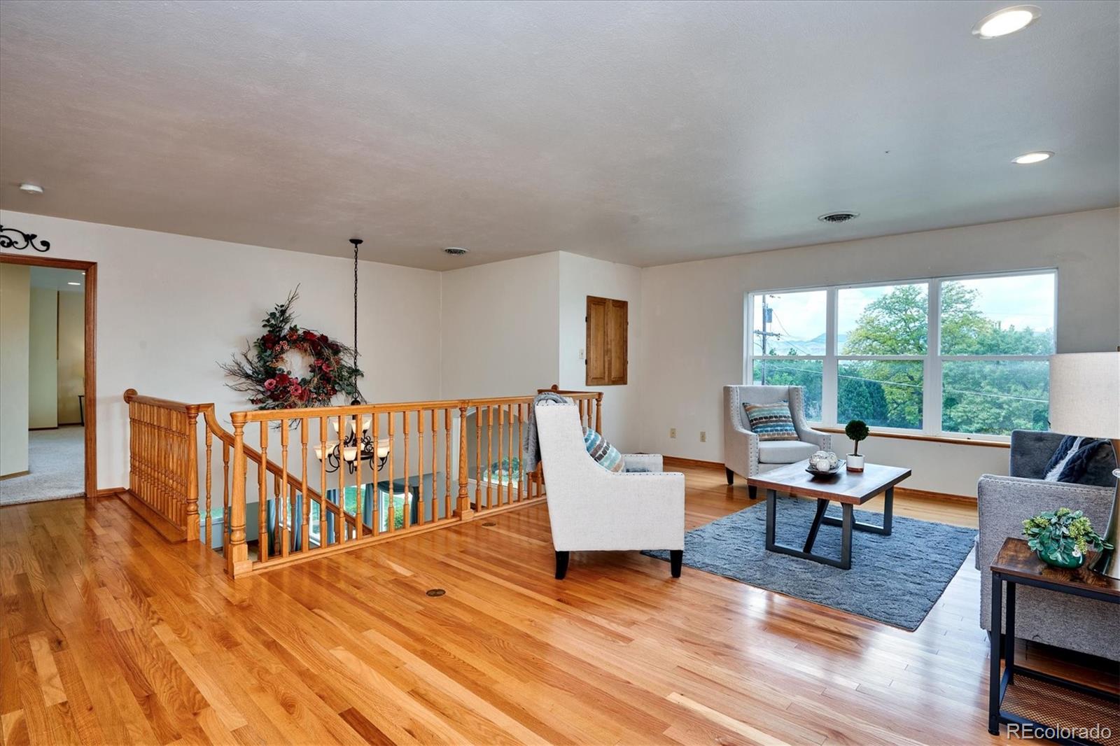 22 Rangeview Drive Wheat Ridge, CO 80215 - Photo 26 of 40 a living room with furniture windows and wooden floor