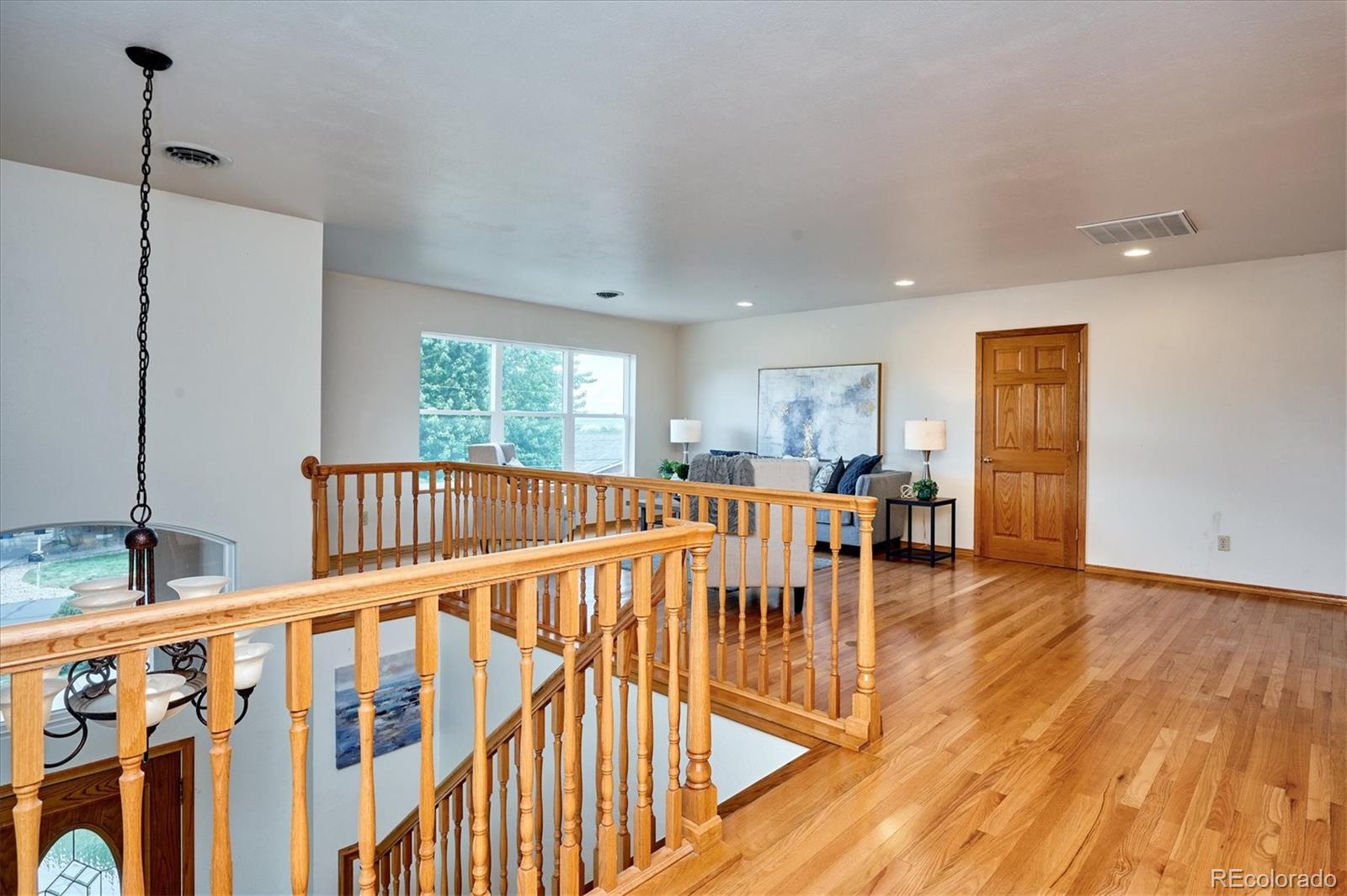 22 Rangeview Drive Wheat Ridge, CO 80215 - Photo 27 of 40 a view of a hallway with wooden floor and windows