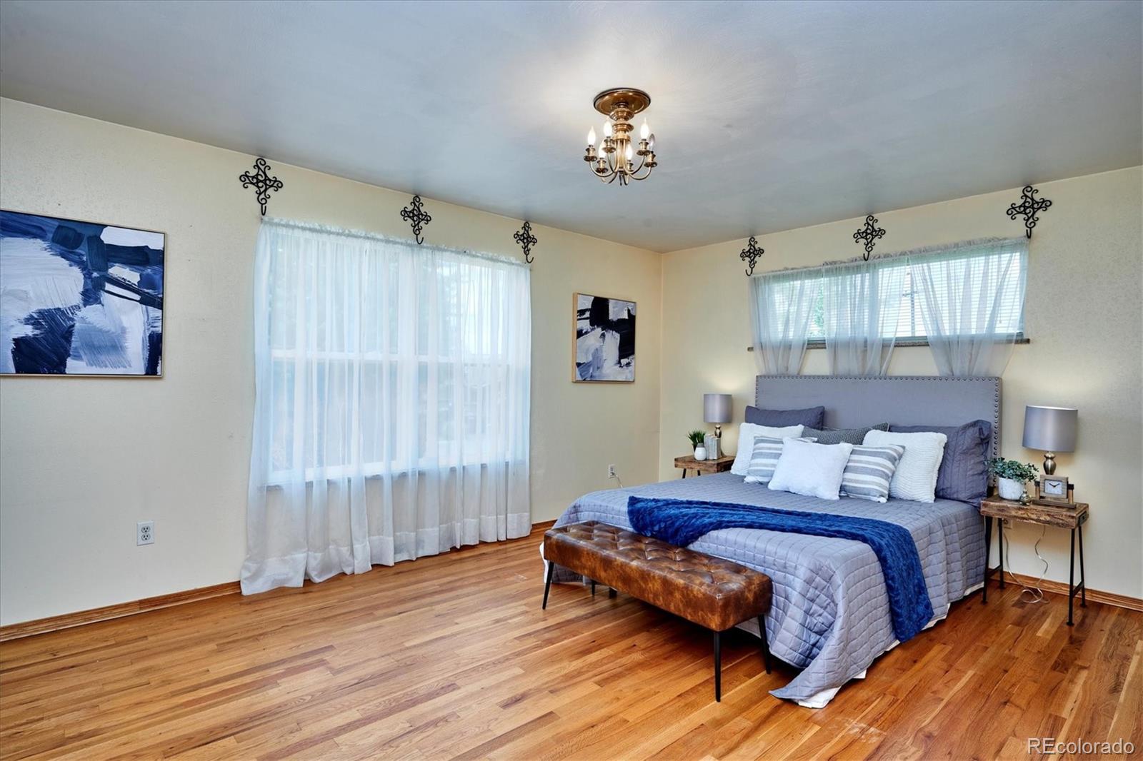 22 Rangeview Drive Wheat Ridge, CO 80215 - Photo 28 of 40 a bedroom with a bed and wooden floor