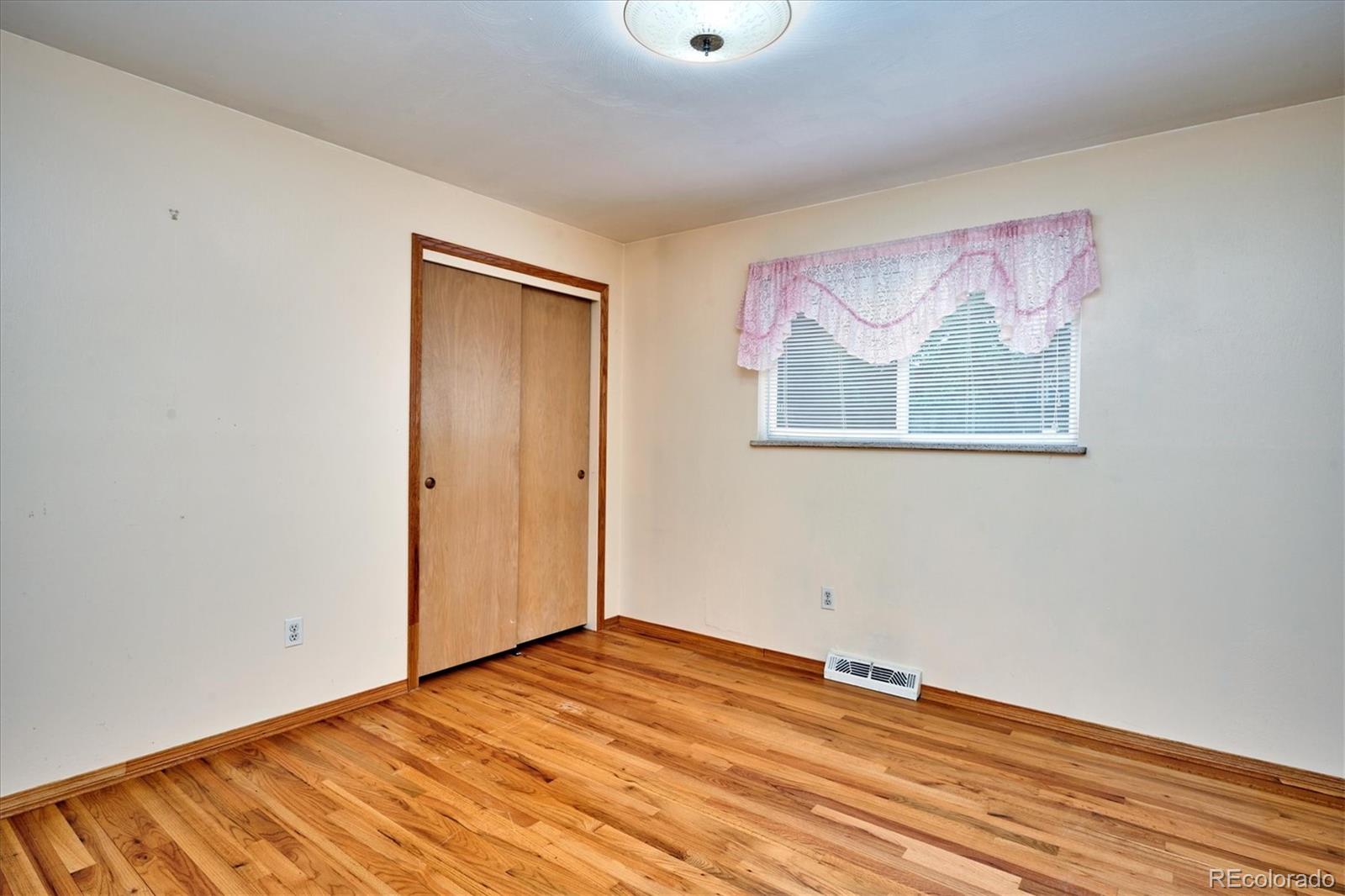 22 Rangeview Drive Wheat Ridge, CO 80215 - Photo 30 of 40 a view of empty room with wooden floor