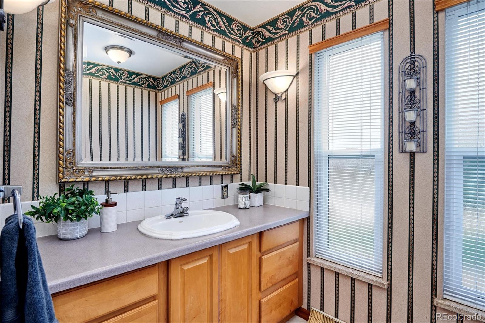 22 Rangeview Drive Wheat Ridge, CO 80215 - Photo 32 of 40 a bathroom with a sink and a mirror
