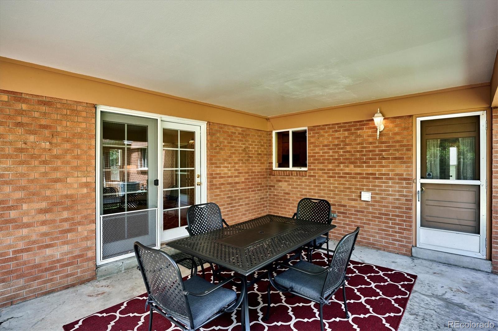 22 Rangeview Drive Wheat Ridge, CO 80215 - Photo 36 of 40 a blue table and chair in front of door