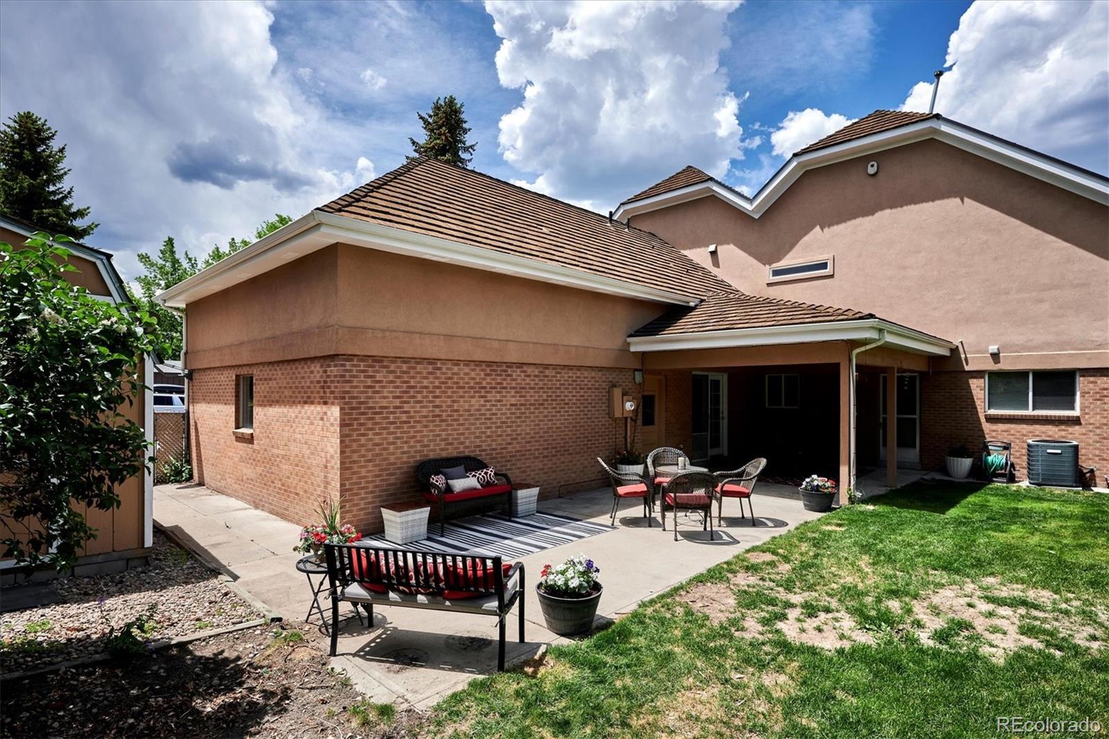 22 Rangeview Drive Wheat Ridge, CO 80215 - Photo 39 of 40 a view of a patio with table and chairs under an umbrella
