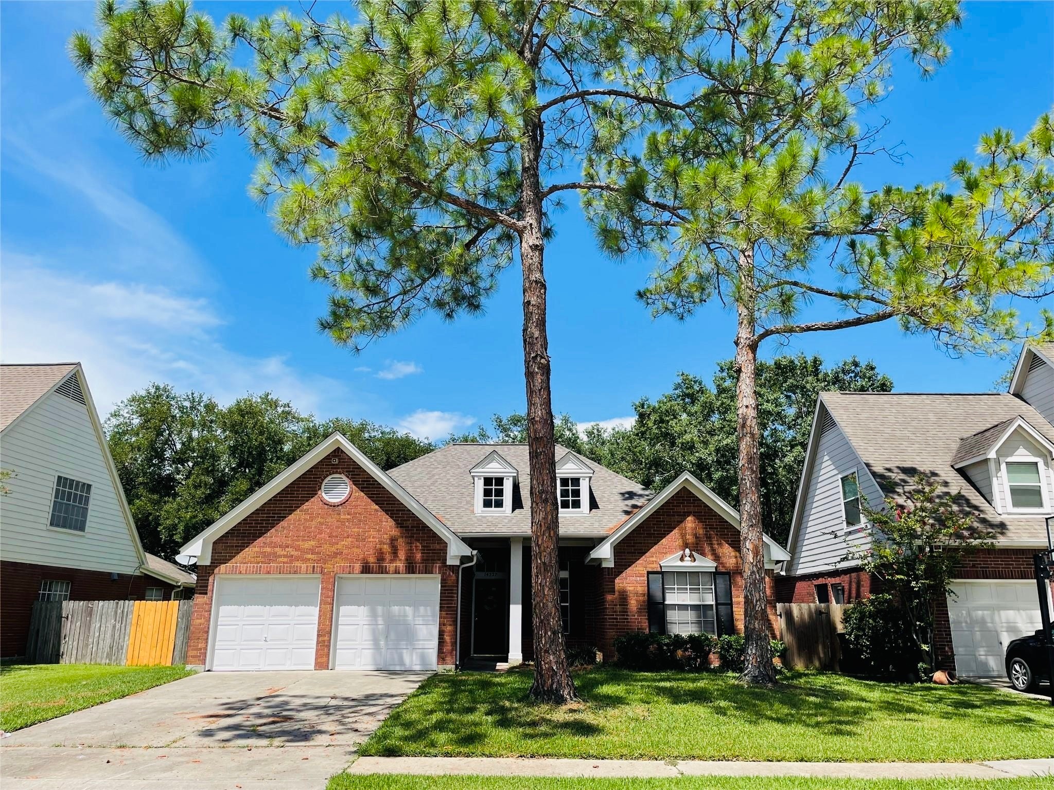 14527 Circlewood Way Houston, TX 77062 - Photo 1 of 14 a front view of a house with a yard and garage