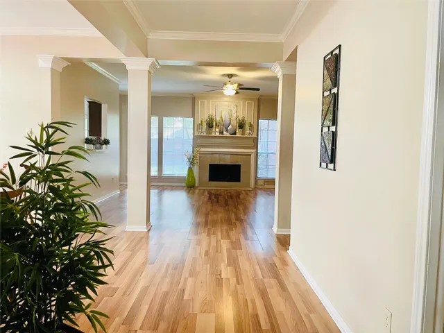 a view of a hallway view with wooden floor and staircase