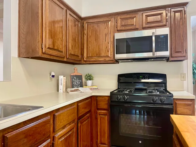 a kitchen with stainless steel appliances granite countertop a stove and a microwave