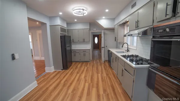 a kitchen with stainless steel appliances a stove a refrigerator and a sink
