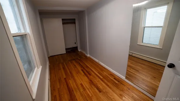 a view of a hallway with wooden floor