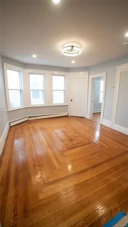 a view of a room with wooden floor and a window