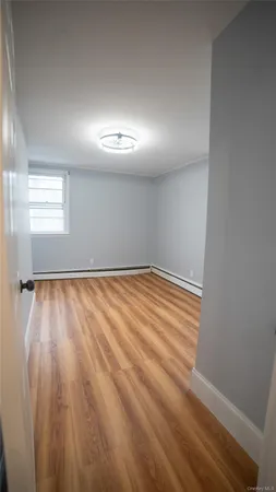 a kitchen with stainless steel appliances a refrigerator a sink and wooden floors