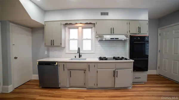 a kitchen with stainless steel appliances a refrigerator and a stove top oven