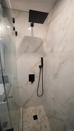 a bathroom with a shower and a sink
