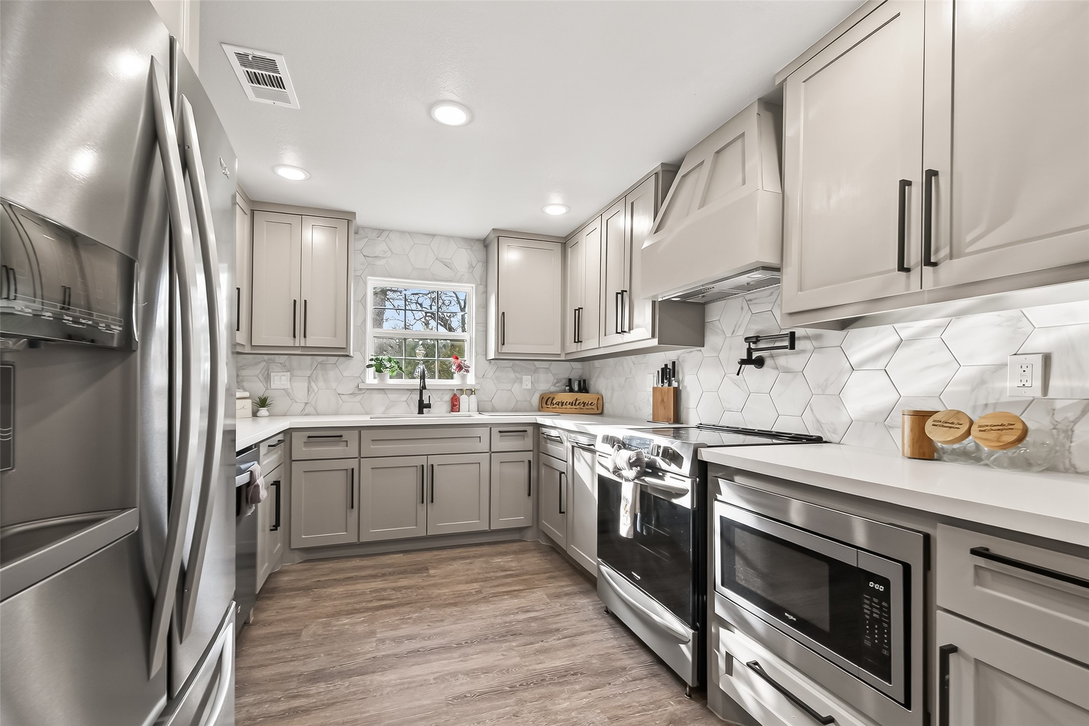 1047 Dungens Mill Road Columbus, TX 78934 - Photo 10 of 44 Modern quartz countertops, soft-close cabinets, and practical layout make the kitchen a standout.