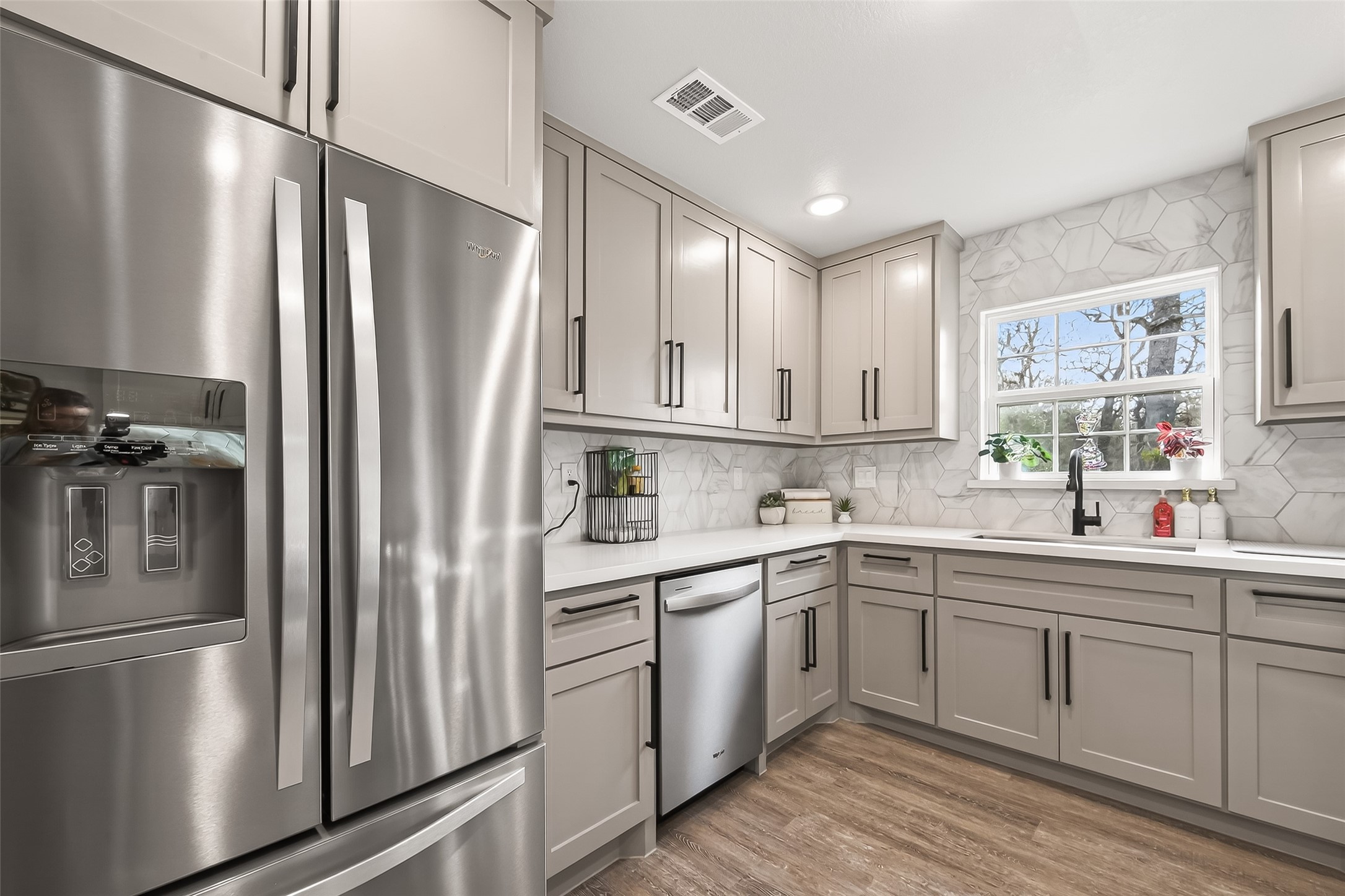 1047 Dungens Mill Road Columbus, TX 78934 - Photo 11 of 44 Spacious fridge, gorgeous backsplash and wonderful kitchen window letting in an abundance of natural light.