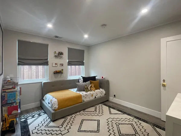 a bedroom with furniture and a window