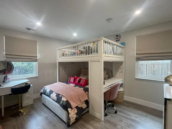 a bedroom with a bed a table and a window