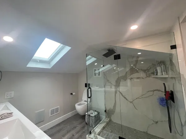 a bathroom with a toilet sink and shower