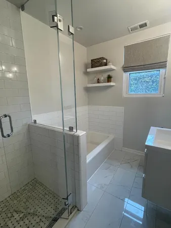 a bathroom with a bathtub and a shower